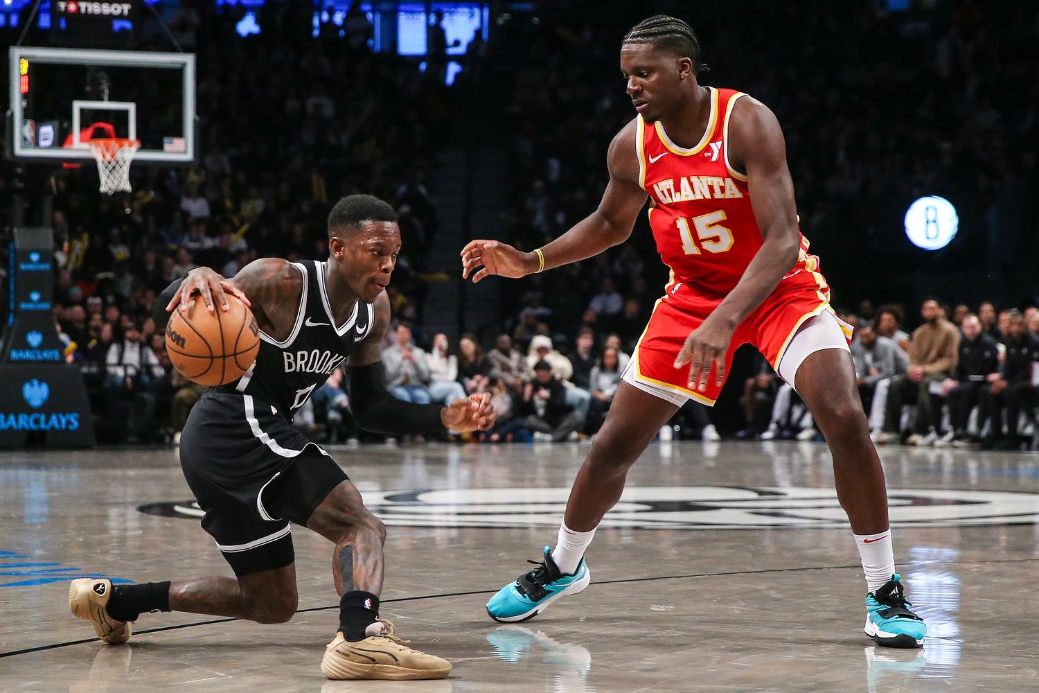 Mar 2, 2024; Brooklyn, New York, USA; Brooklyn Nets guard Dennis Schroder (17) controls the ball as Atlanta Hawks center Clint Capela (15) defends in the fourth quarter at Barclays Center. Mandatory Credit: Wendell Cruz-USA TODAY Sports